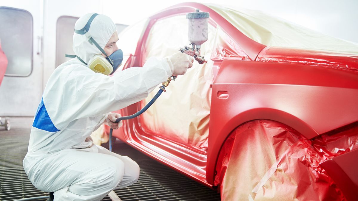 Car being repainted in a professional spray booth